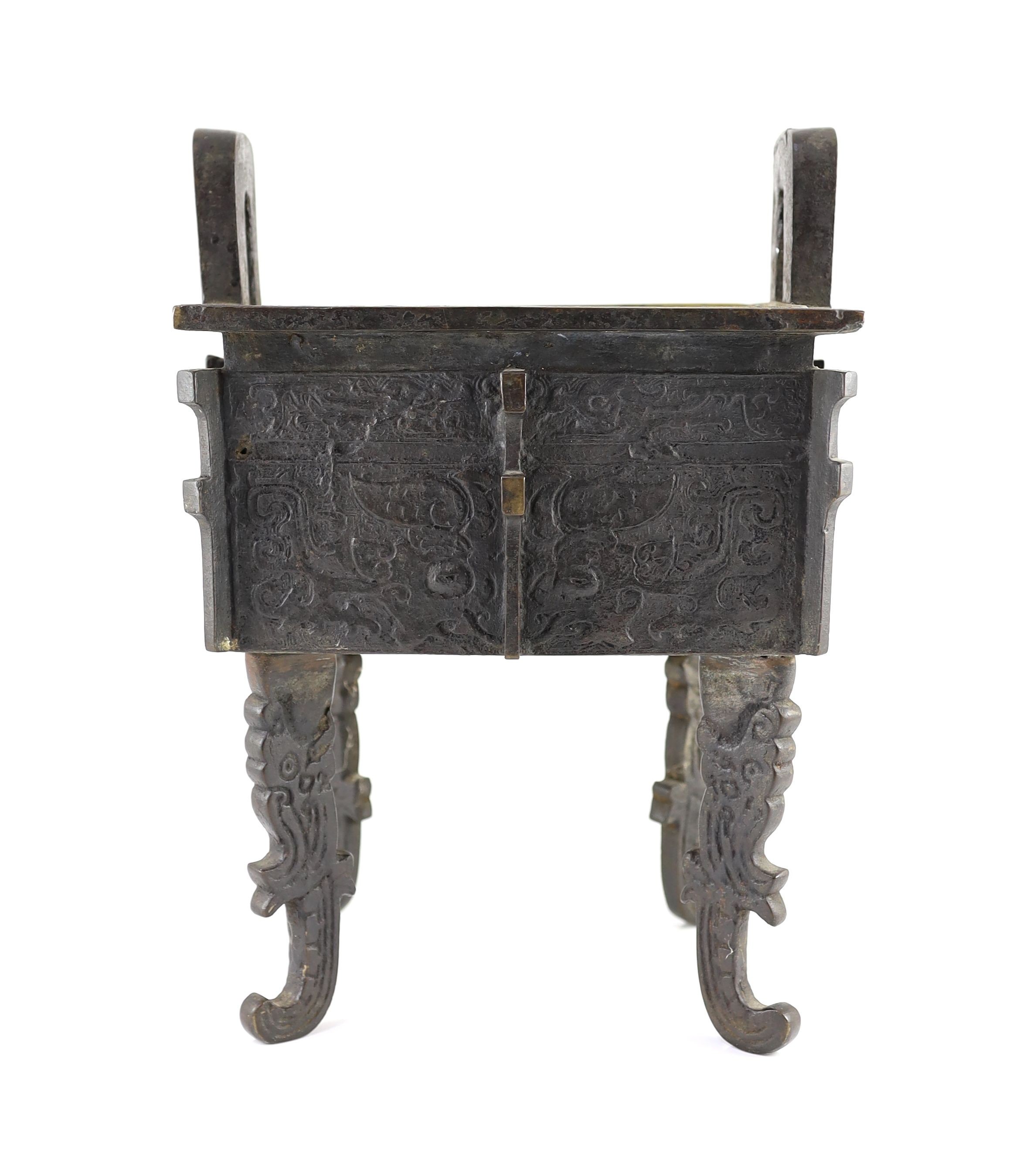 A Chinese archaistic bronze rectangular censer, fangding, 17th/18th century 34cm high, 24cm wide, 20cm depth later liner and repairs to legs